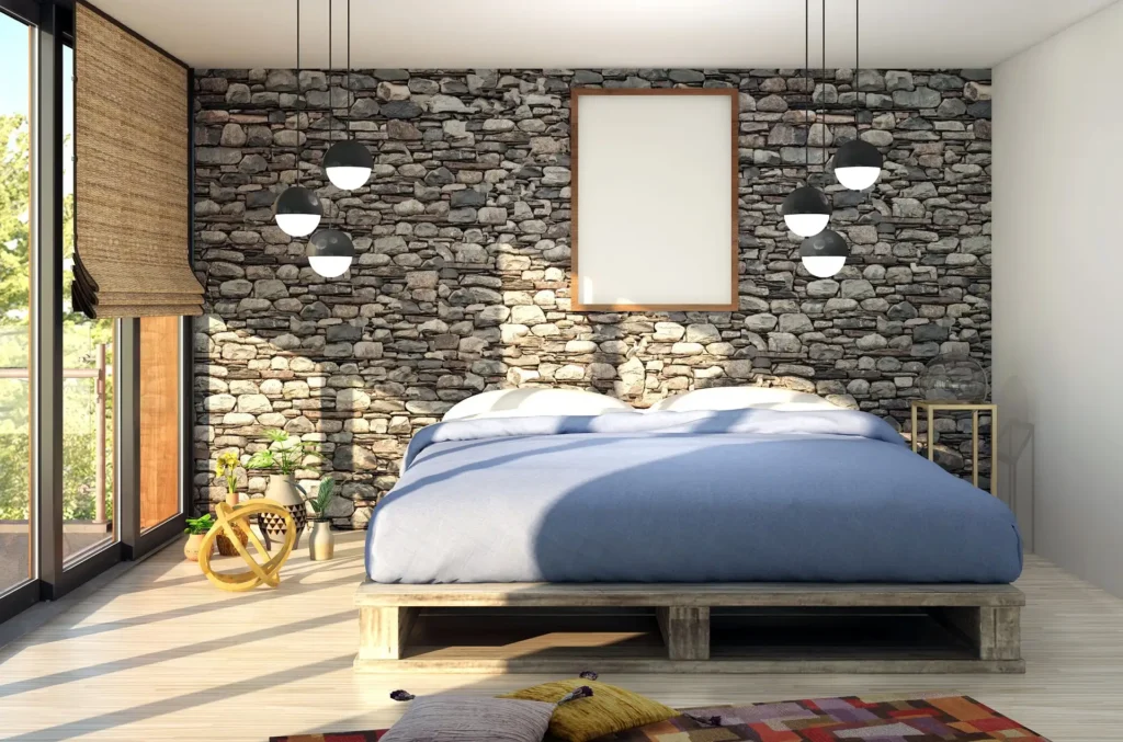 Modern bedroom with a minimalist platform bed, blue bedding, and a rustic stone accent wall